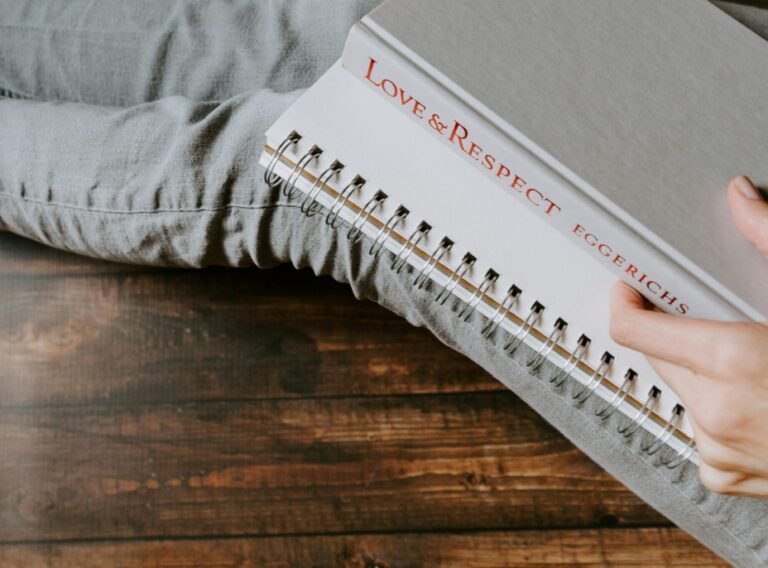 person holding white notebook person holding white notebook